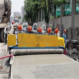 Concrete road paver machine