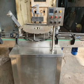 Automatic S.S. Covering Rotary Conduction Heat sealing machine, Capacity: 10 To 12 Bottle Per Minute